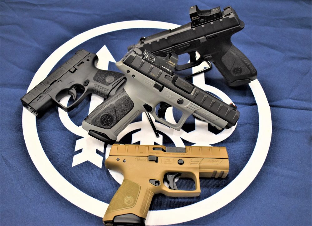 A table top of several Beretta APX pistols in a variety of shapes, sizes and colors