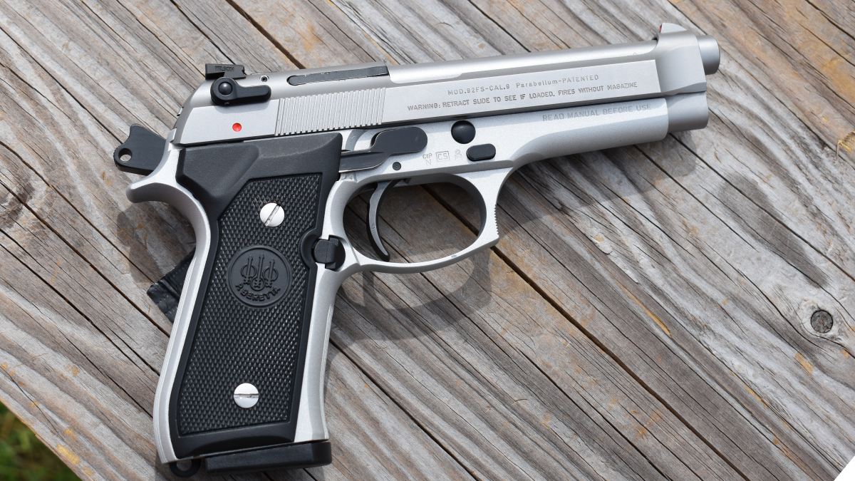 A Beretta 92F Inox stainless on a wooden table