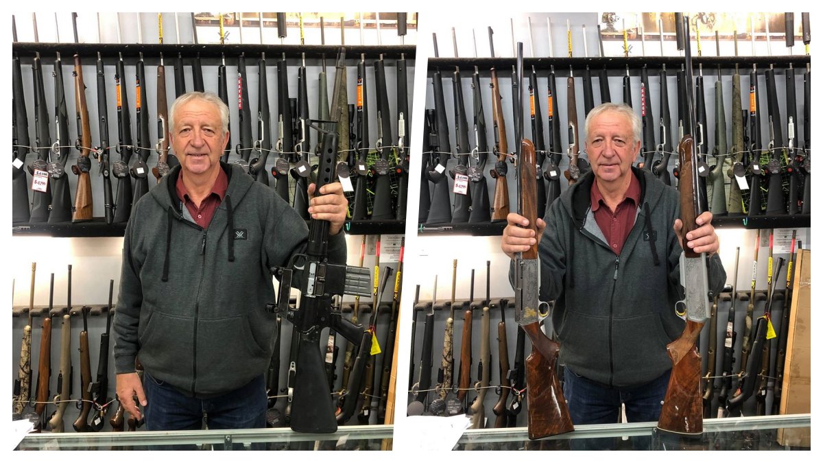 A man holds semi-auto rifles behind a gun store counter in New Zealand