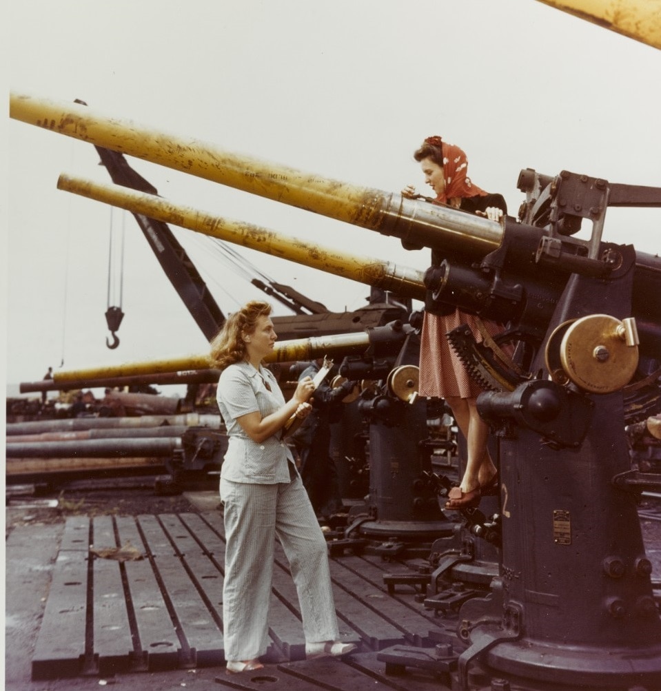 80-G-K-13604 Dahlgren A woman ordnance worker or wow writes down data from a sister employee concerning the 3 50 D.P. gun they have been test firing.